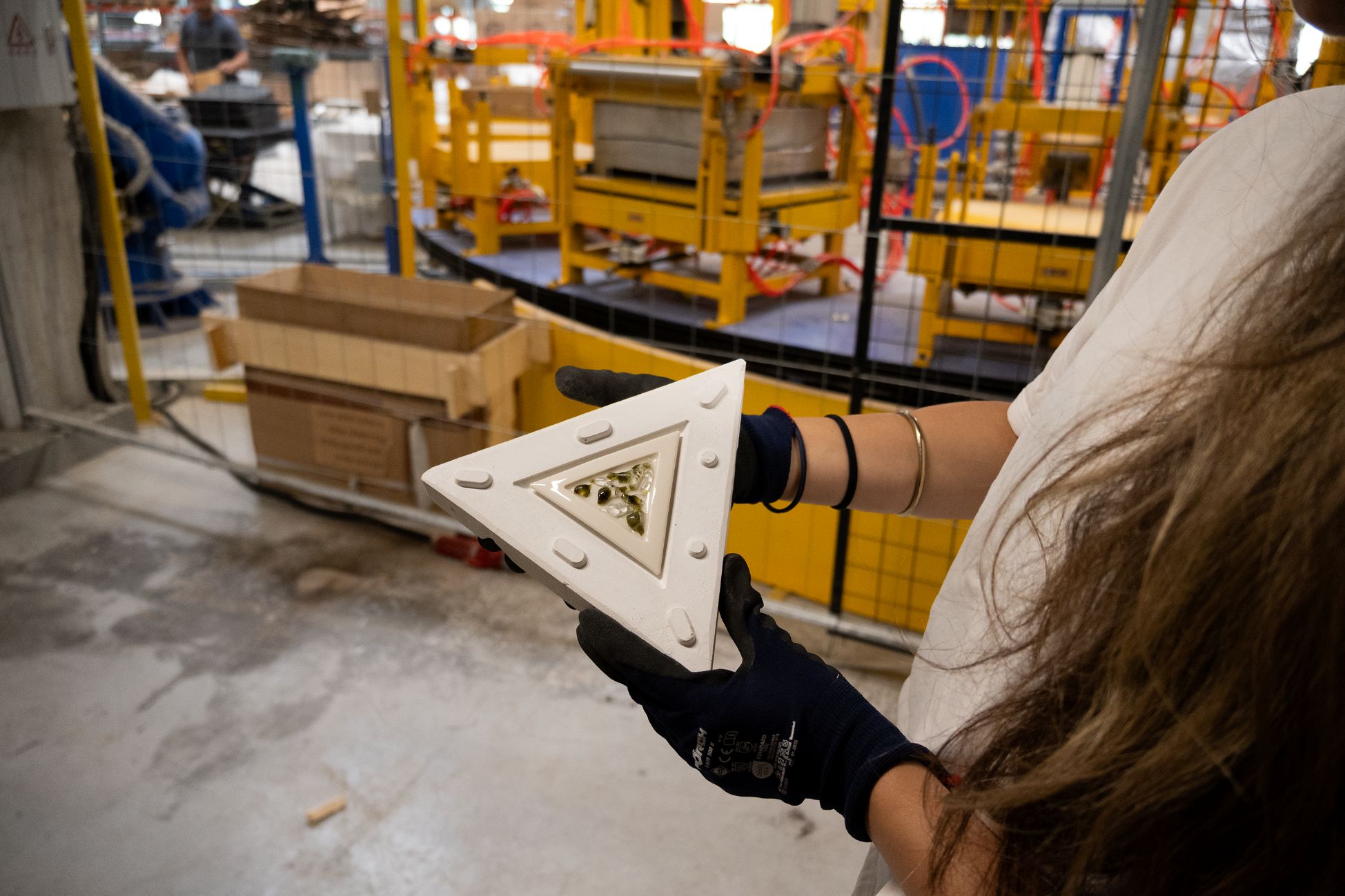 3D-printed triangular part held up at the Center of Excellence for Furniture
