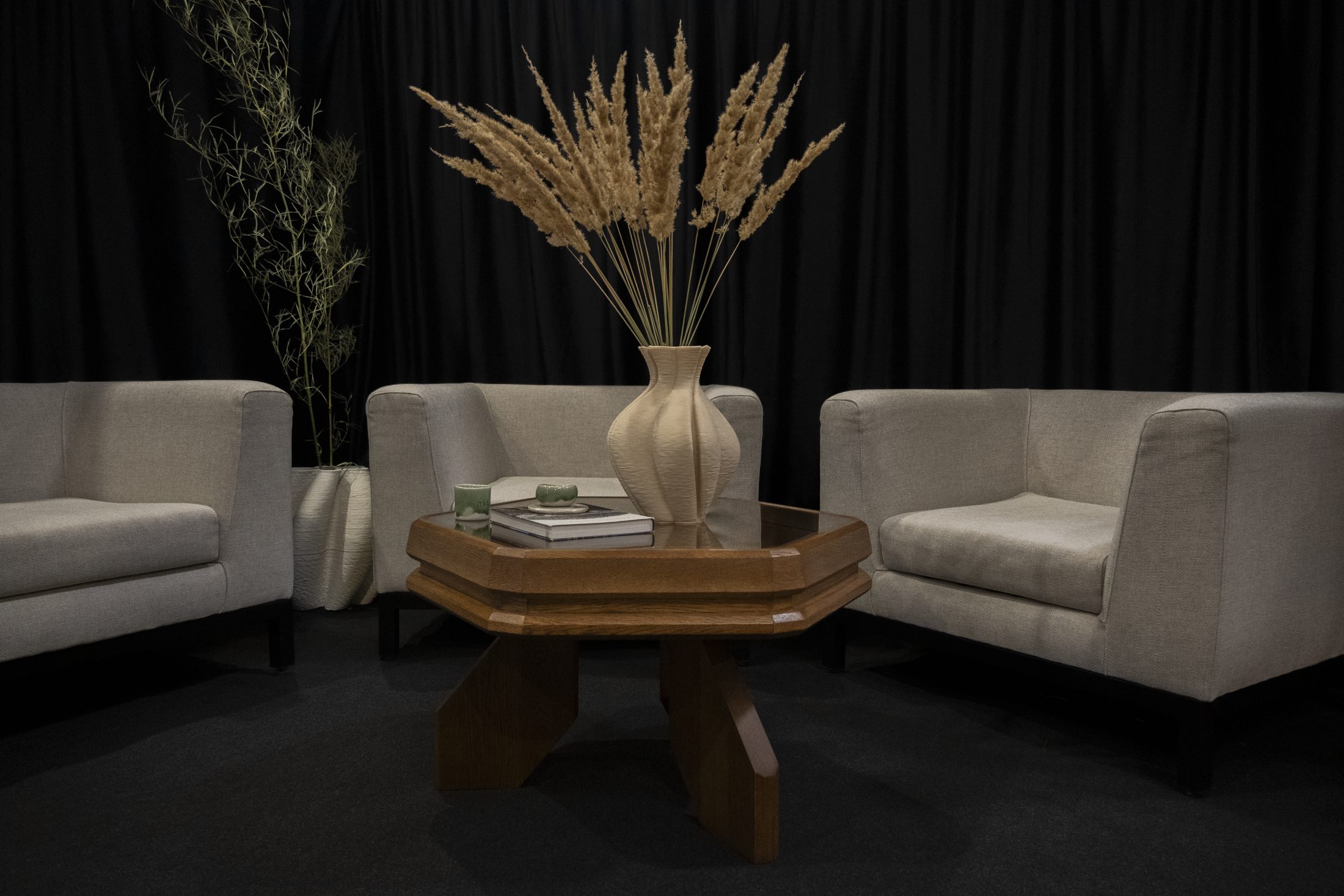 Fagora® table in a lounge setting between armchairs